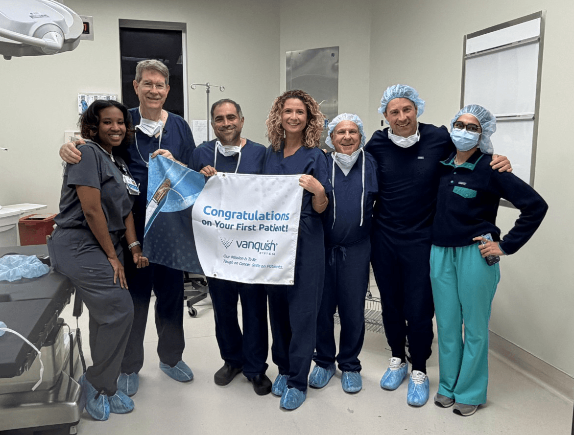 Expanded clinical team celebrating the first Vanquish patient treatment